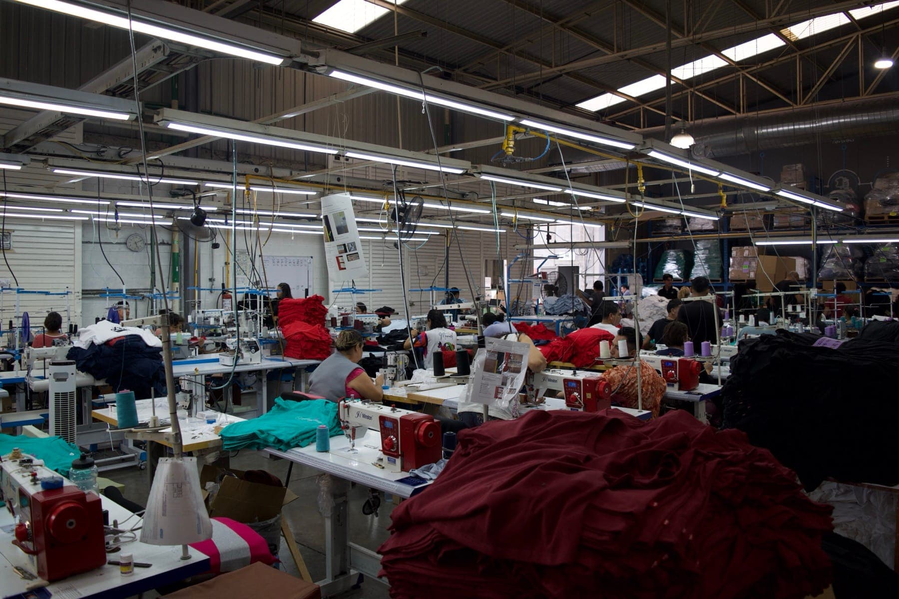 Apparel sewing workshop with workers at their machines